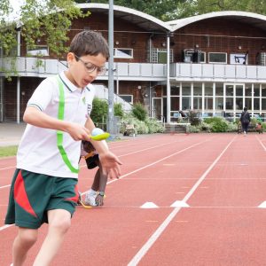 Students running down the athletics track