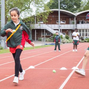 Students running down the athletics track