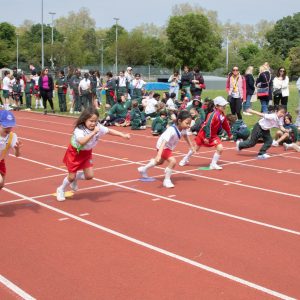 Students running on the athletics track