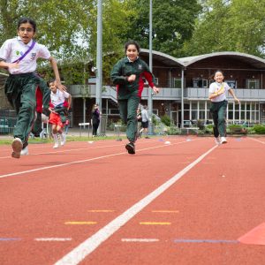 Students running on the athletics track
